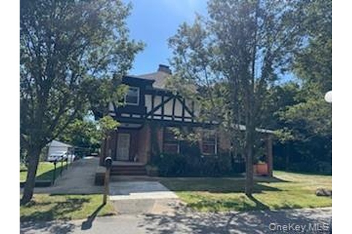 Tudor house featuring a front yard