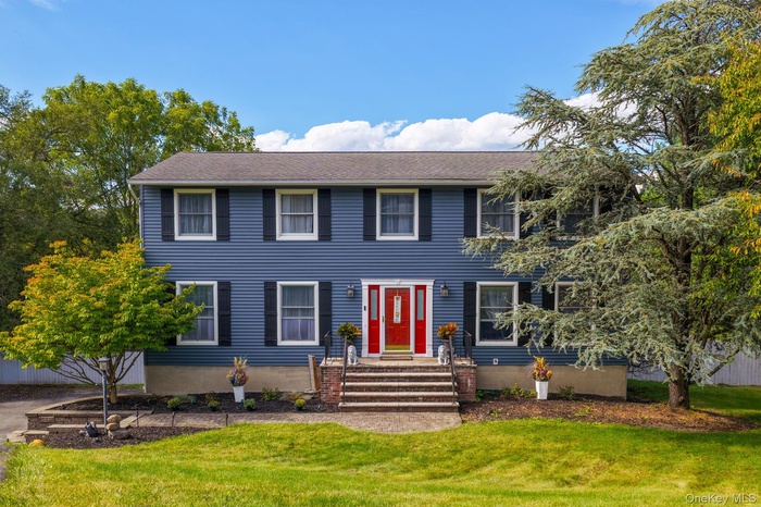 Colonial home with a front lawn