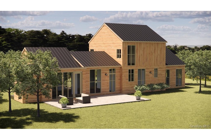 Back of property featuring a patio area, metal roof, and a yard