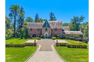 Step into timeless elegance with this one of a kind Tudor residence, perfectly situated in the highly coveted gated community of Kennilworth in Kings Point.