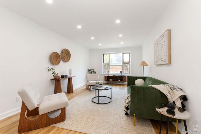 Living area featuring light wood-type flooring and recessed lighting