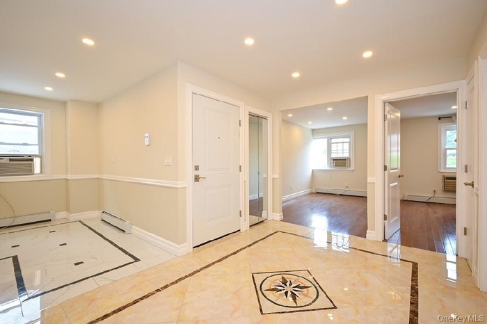 Bonus room featuring recessed lighting, baseboard heating, a baseboard radiator, inlaid floor details, and cooling unit