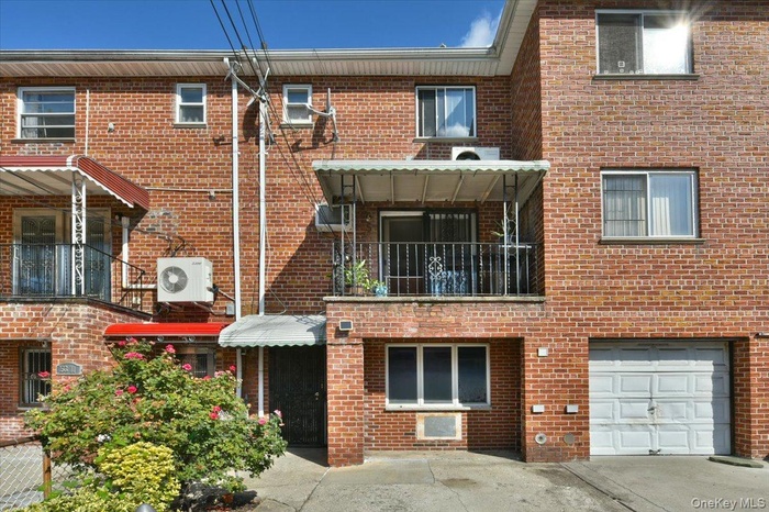 View of building exterior featuring a garage