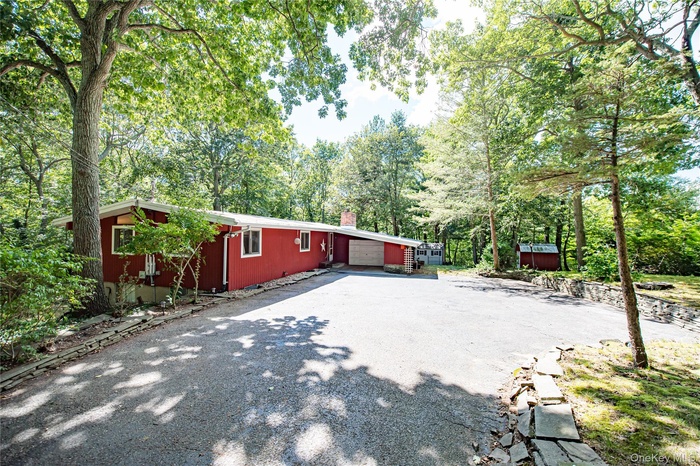 View of home's exterior with driveway and a chimney