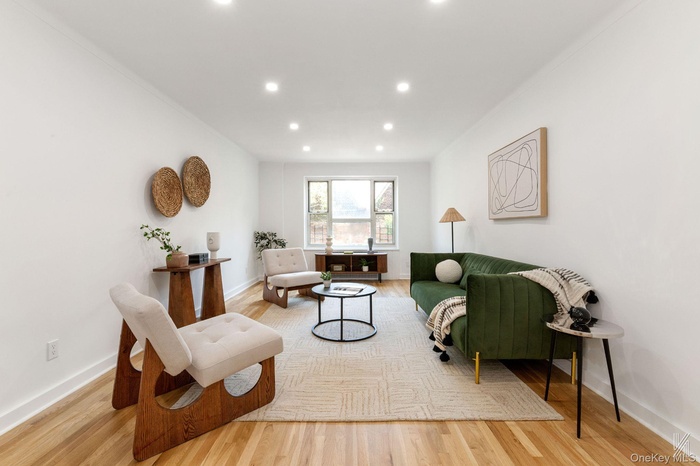 Sitting room with light wood-style floors and recessed lighting