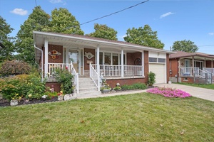 Situated on a quiet, tree lined street, this solid brick bungalow offers a thoughtfully updated interior and a beautifully landscaped exterior.