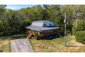 Escape to nature without sacrificing modern comforts in this beautifully updated two storey farmhouse nestled on 12 acres of protected forest in the heart of Prince Edward County.