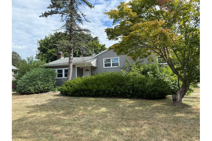 Tri-level home (Split Style) with a front yard and a chimney