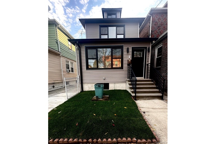 American foursquare style home with a front lawn
