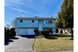 Welcome to this charming hi ranch home offering versatility and space for comfortable living.