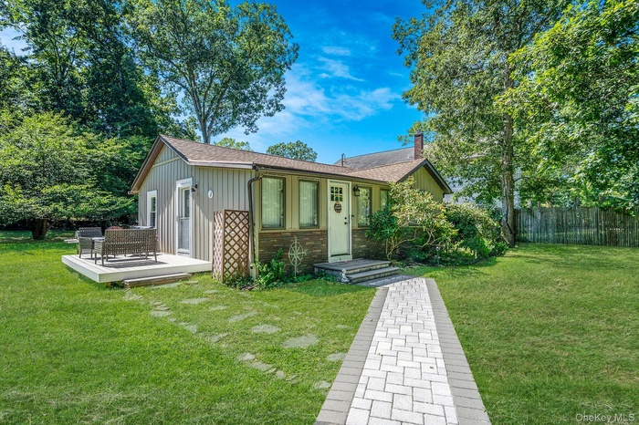 View of front of home featuring board and batten siding, a chimney, and roof with shingles