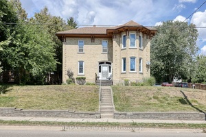Welcome to 135 Canterbury Street, Ingersoll, a stately yellow brick triplex with timeless character and modern updates.