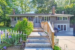 Charming 3 bedroom, 2 bath split level style home nestled on a spacious half acre lot in a desirable beachside POA community.