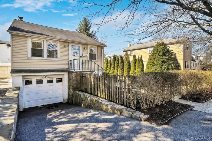 View of front of property featuring driveway and an attached garage