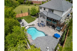 Situated on an expansive pie shaped lot surrounded by nature, this stunning residence is thoughtfully crafted with every detail in mind.