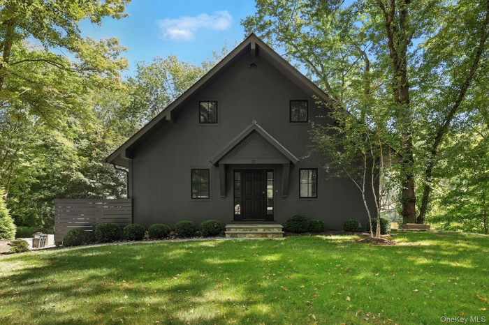View of front facade featuring stucco siding and a front lawn