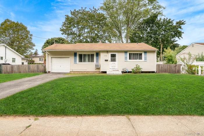 Ranch-style home with driveway and an attached garage