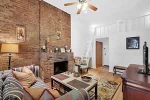 This one of a kind one bedroom residence features dramatic double height ceilings and a versatile sleeping loft, perfect for added living space, storage, or effortlessly hosting guests.