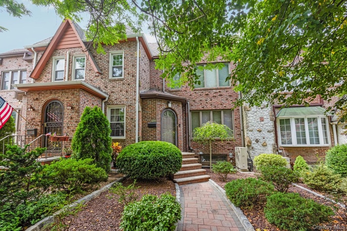 Tudor-style house featuring brick siding