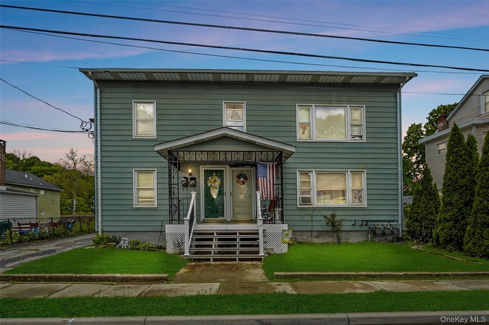 View of front of house with a front yard