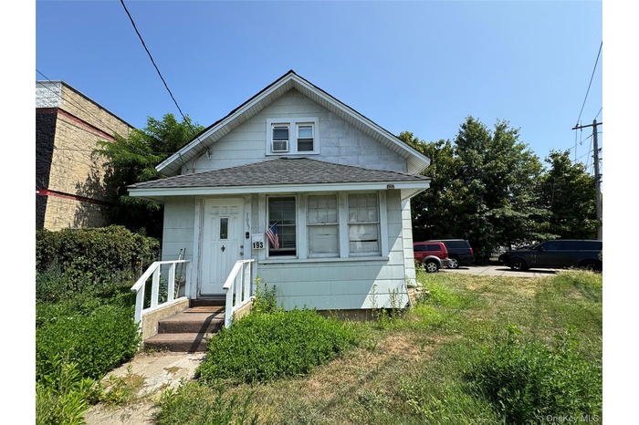 View of front of home featuring roof with shingles