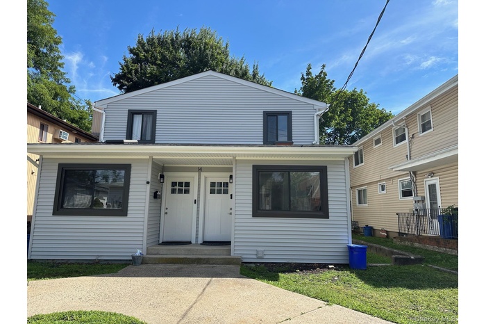 View of front of home featuring a front lawn and a porch