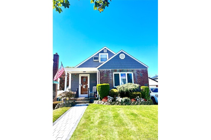 Bungalow-style home with a front lawn and brick siding