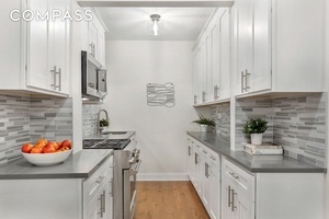 beautifully transformed home boasts a bright, windowed renovated kitchen with sleek stainless steel appliances, modern cabinetry, and updated fixtures.