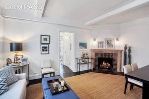 9P is a charming one bedroom apartment with a wood burning fireplace and northern views showcasing some of the city's most iconic buildings, including the Chrysler Building.