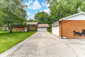 RAISED BUNGALOW ON 1. 2 ACRES WITH A BONUS DETACHED SHOP, SPACIOUS TWO CAR GARAGE, LIGHT FILLED SUNROOM amp ; PEACEFUL BACKYARD RETREAT !
