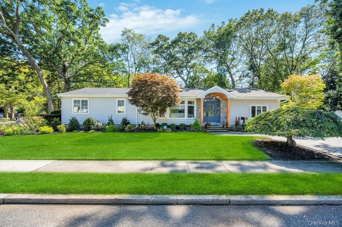 Single story home featuring a front lawn