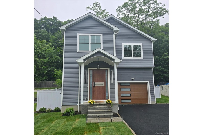 View of front of home featuring a garage and driveway