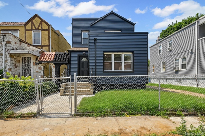 View of front facade with a gate and a fenced front yard