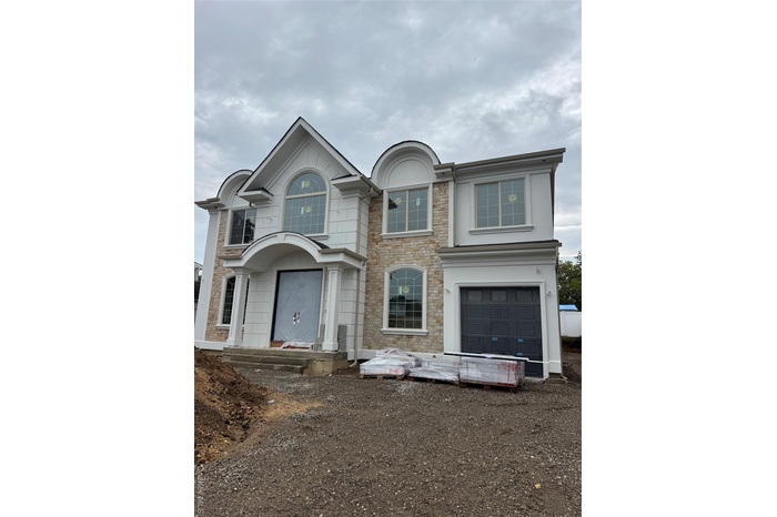 View of front facade with stone siding and stucco siding