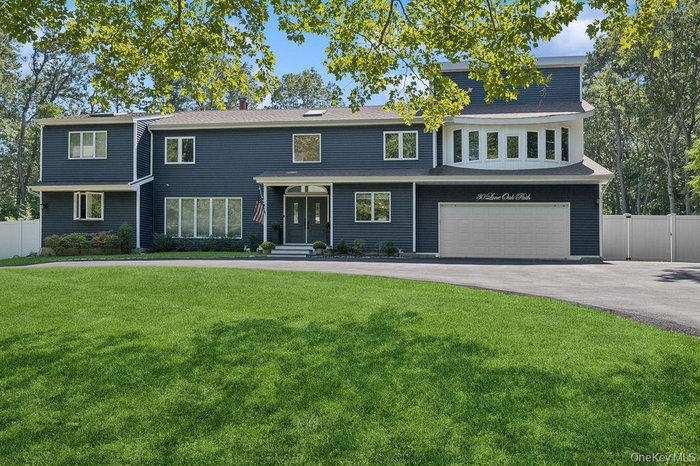 Traditional home with asphalt driveway and an attached garage
