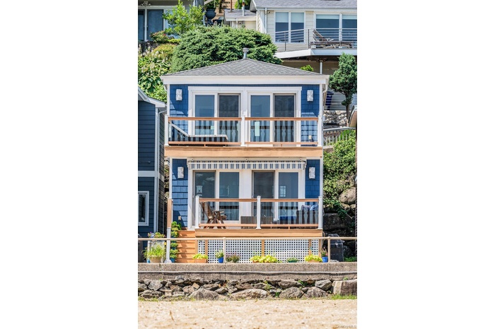 Two story home with a deck and upper balcony