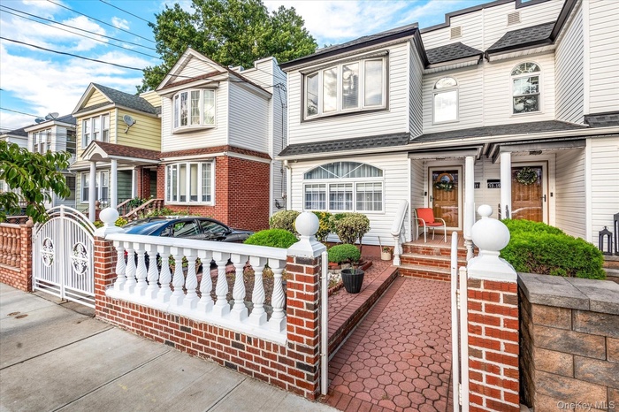 Victorian home featuring a residential view, a gate, and a shingled roof