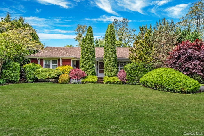 View of front facade featuring a front yard and roof with shingles