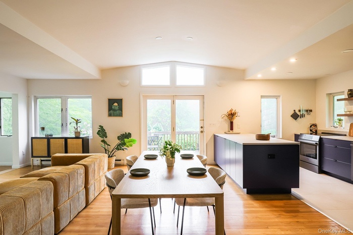 Dining room featuring light wood-type flooring, recessed lighting, and vaulted ceiling
