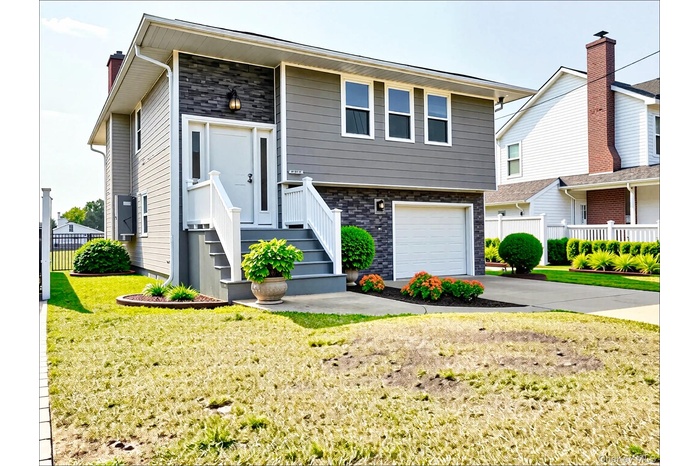 View of front facade featuring concrete driveway, an attached garage, and stone siding