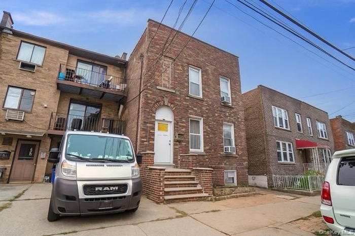 Traditional home featuring a balcony and brick siding