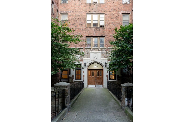 Property entrance with brick siding and french doors
