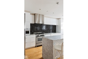 This meticulously renovated Tribeca loft seamlessly blends the iconic character of the neighborhood with contemporary luxury living.