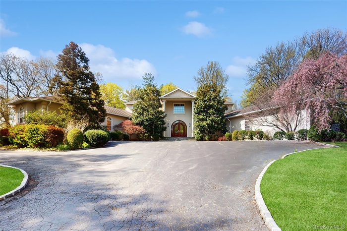 View of front of house with curved driveway