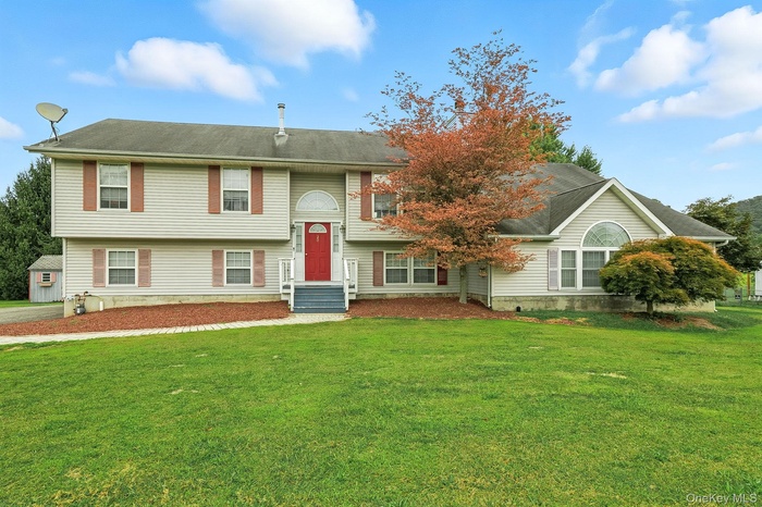 Split foyer home featuring a front yard