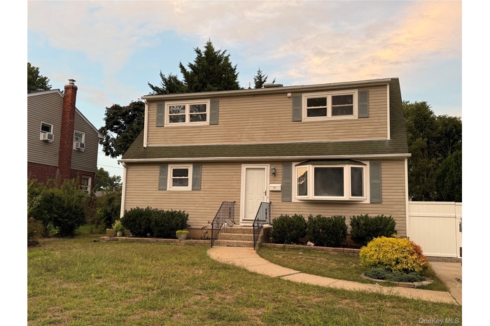 Traditional-style house with a front yard