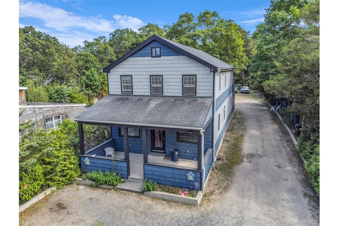 View of front of house with a porch and a shingled roof