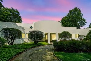 Nestled in breathtaking natural surroundings, this modern architectural masterpiece by renowned designer Myron Goldfinger offers three levels of striking contemporary design.