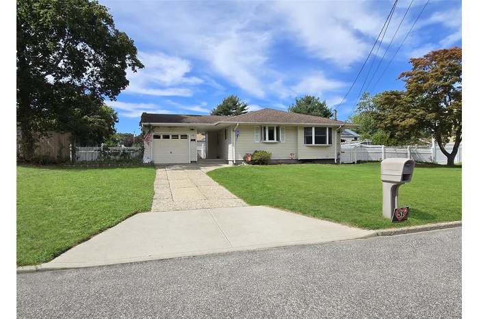 Single story home with concrete driveway and a garage