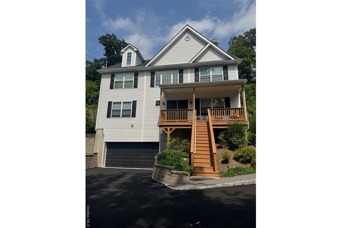Front View, driveway, stairs, 2 garage, and a porch